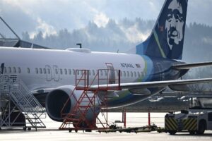 (FILES) Alaska Airlines N704AL, a 737 Max 9, which made an emergency landing at Portland International Airport on January 5 is parked at a maintenance hanger in Portland, Oregon on January 23, 2024. The missing emergency door is covered and taped. Aviation giant Boeing has been unable to produce key information about work performed on an Alaska Airlines plane before a January mid-air scare, said the National Transportation Safety Board chair in a letter on March 13, 2024. Patrick T. Fallon / AFP