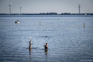 HELLEVOETSLUIS - Mensen op warme nazomerdag op een strand. De zomer van 2023 zal de boeken in gaan als de warmste zomer ooit in Nederland. ANP ROBIN UTRECHT