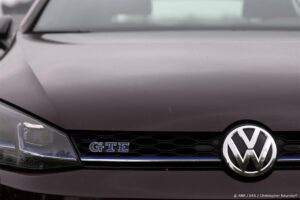 epa11584084 The Volkswagen logo is seen on an e-car (E-Golf) at the Volkswagen (VW) vehicle factory in Osnabruck, Germany, 04 September 2024. Europe's largest car manufacturer announced that it would tighten austerity measures at its core VW brand. Volkswagen Group said it can no longer rule out plant closures in Germany.  EPA/CHRISTOPHER NEUNDORF