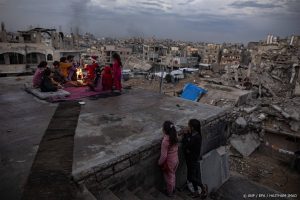 epaselect epa11807841 Amr Abu Hashem (C), a 26-year-old displaced Palestinian from Khan Younis, sits with a Palestinian family on the roof of their destroyed house as he dressed as Santa Claus to tour the destroyed homes and temporary tent shelters of displaced families in Khan Younis, Gaza Strip, distributing candy and entertaining children, 05 January 2025. Omar, who lost a leg during one of the wars in the Gaza Strip, says he took this initiative to bring some joy to displaced children ahead of the Eastern Christmas celebrations despite the difficult circumstances. More than 45,300 Palestinians and over 1,400 Israelis have been killed, according to the Palestinian Health Ministry and the Israeli Army, since Hamas militants launched an attack against Israel from the Gaza Strip on 07 October 2023, and the Israeli operations in Gaza and the West Bank which followed it.  EPA/HAITHAM IMAD  ATTENTION: This Image is part of a PHOTO SET